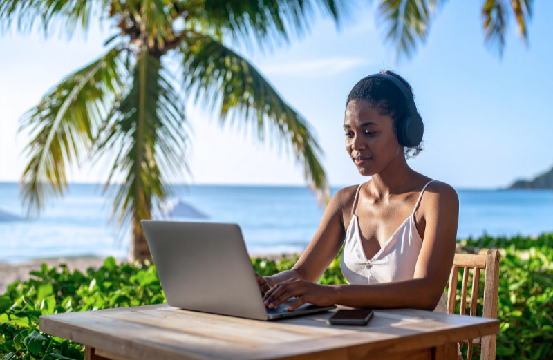 A woman working on her computer during a workation.