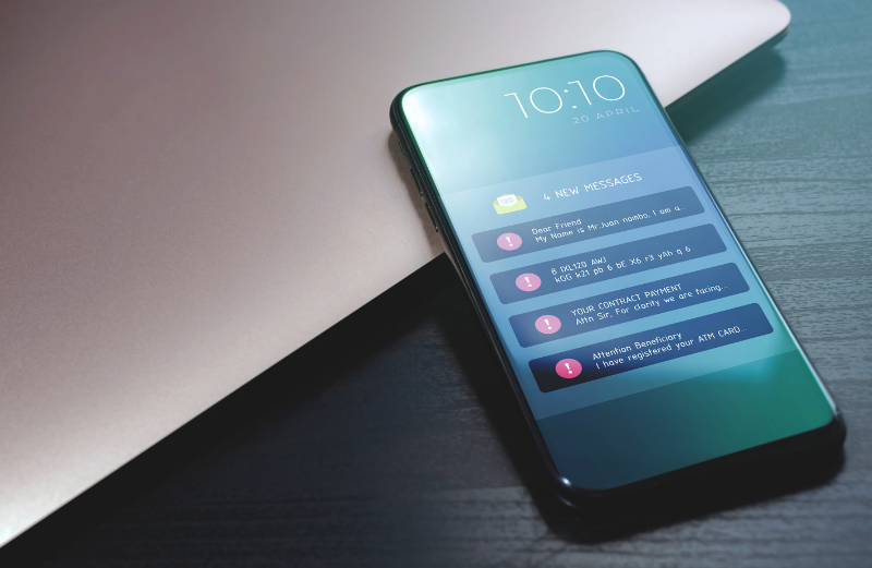 A mobile phone display showing four received phishing messages. Passkeys are resistant to phishing.