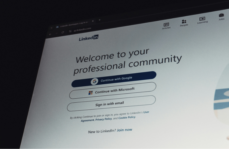 Close-up of a computer screen showing a user logging into LinkedIn.