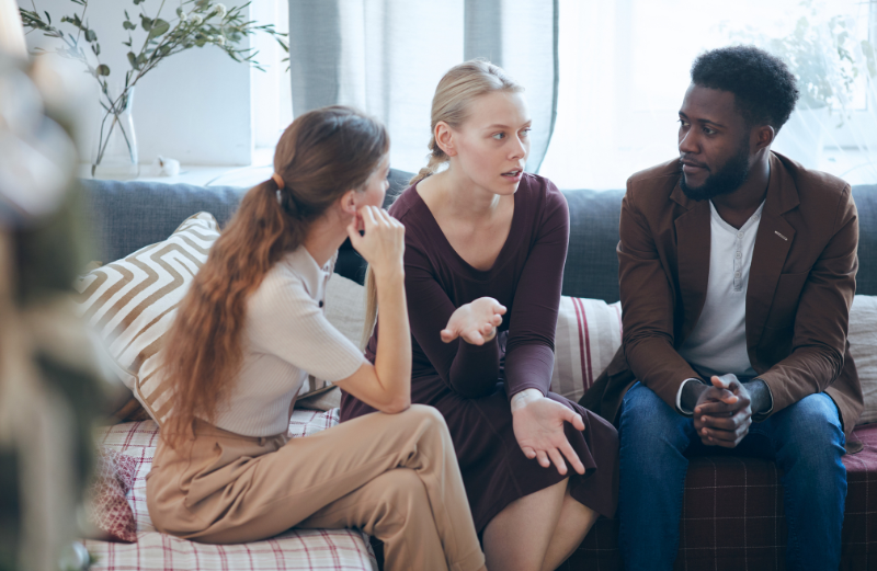Colleagues are chatting on the couch. Diversity within an organisation can also be supported by allies who stand up for coworkers facing discrimination.